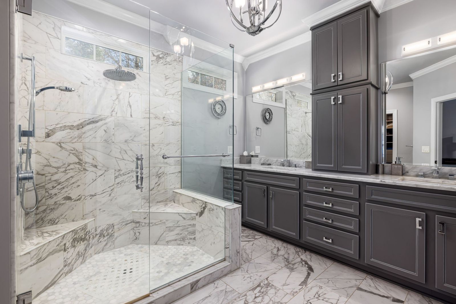 Long charcoal bathroom vanity with a tall linen cabinet beside a marble shower (example style photo)