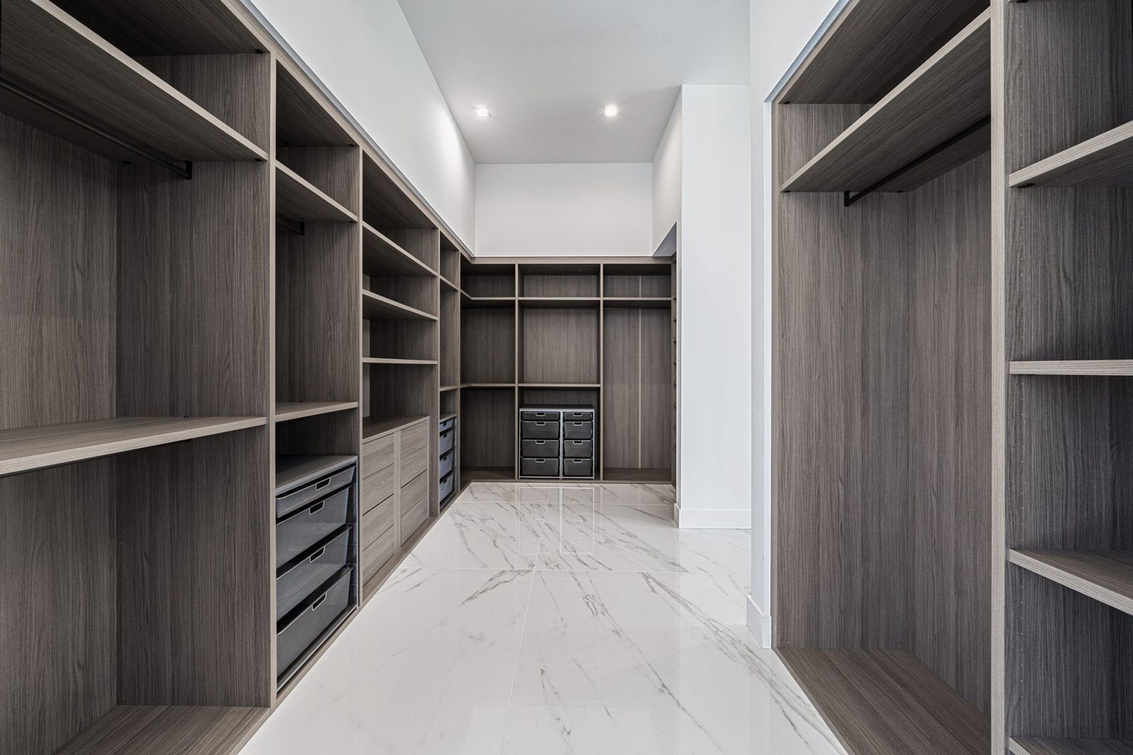 Walk-in closet with gray wood-grain shelving and hanging sections (example style photo)