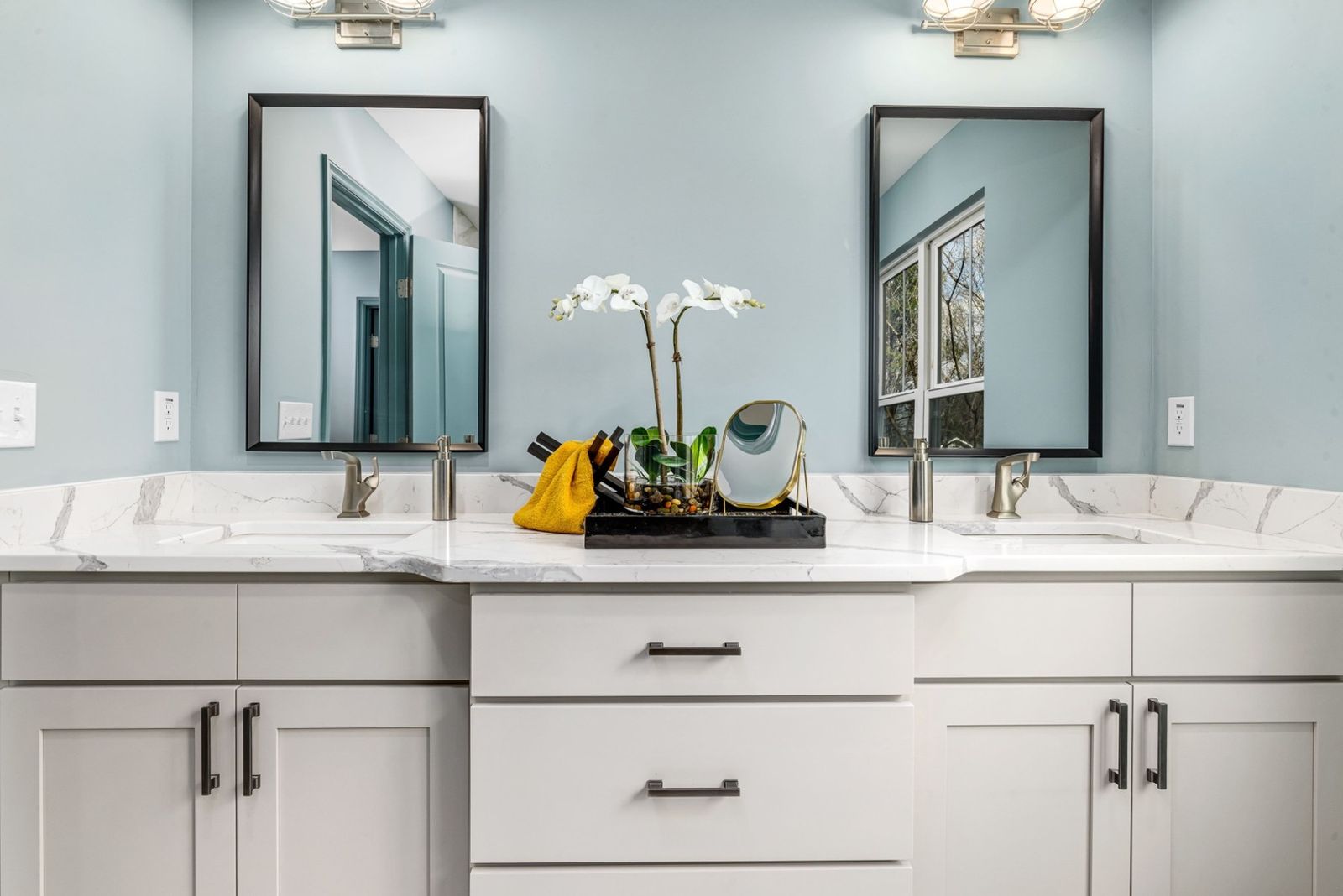 White double vanity with drawers, a quartz top and two framed mirrors (example style photo)